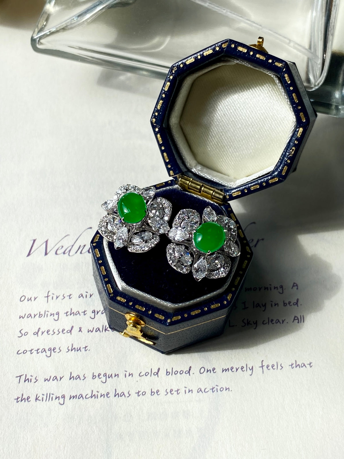 Green jade cabochon stud earrings with clear crystal cluster displayed in blue box