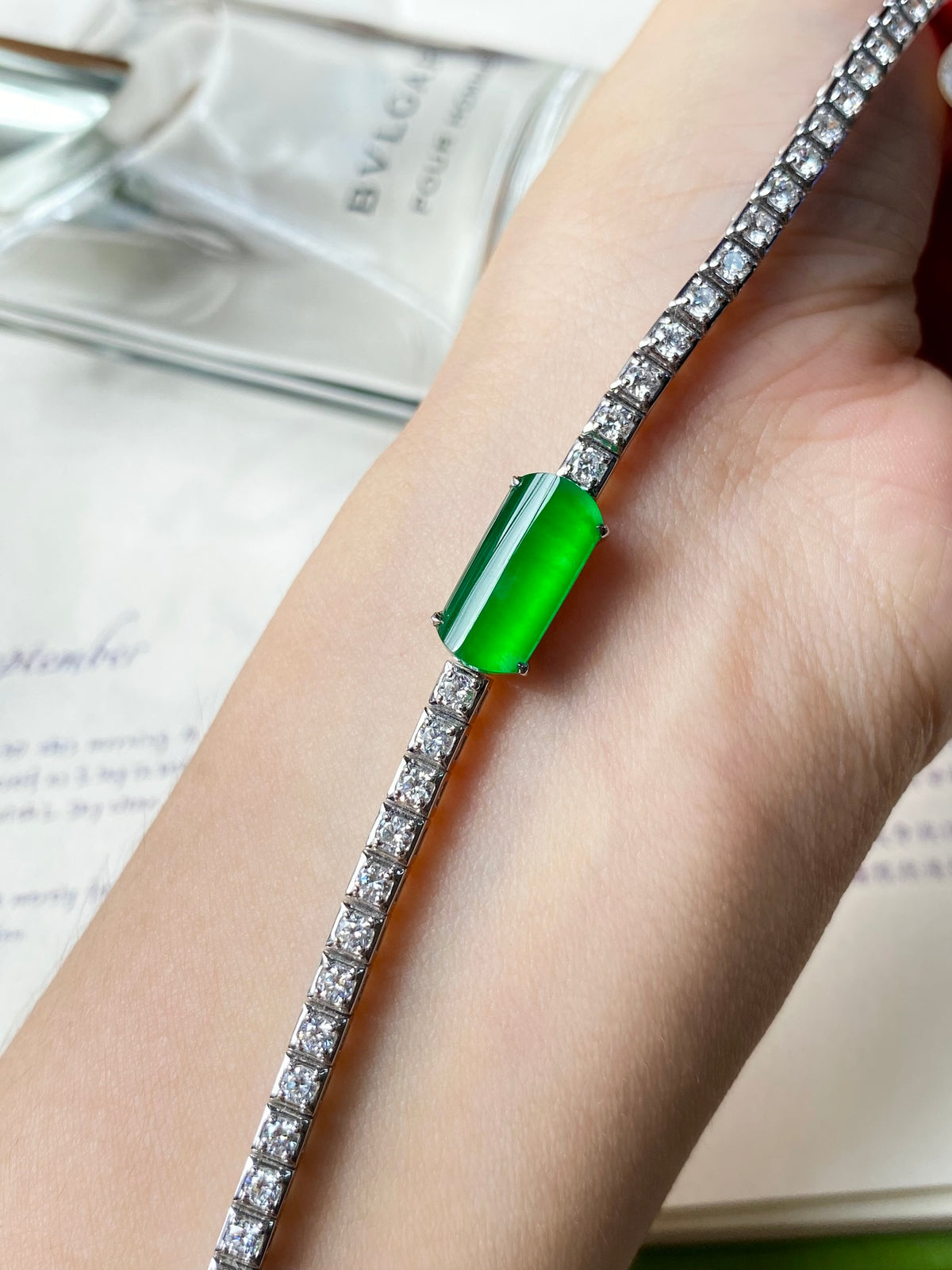 Jadeite cabochon bracelet with bright green center stone and silver-tone crystal links