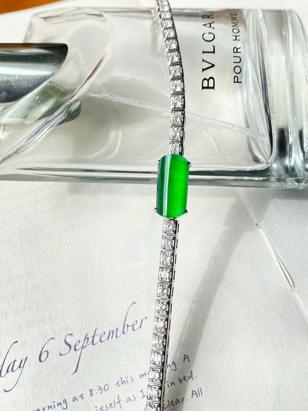 Jadeite cabochon bracelet with silver tennis-style band and bright green center stone