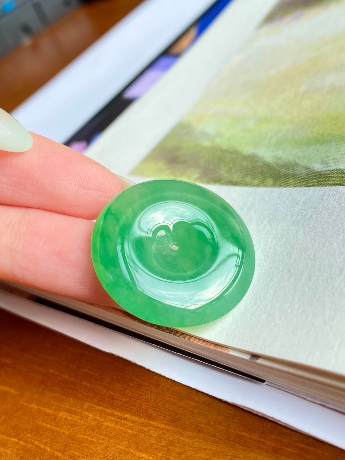 Green jadeite donut stone, unmounted; circular with central opening, high-gloss translucent