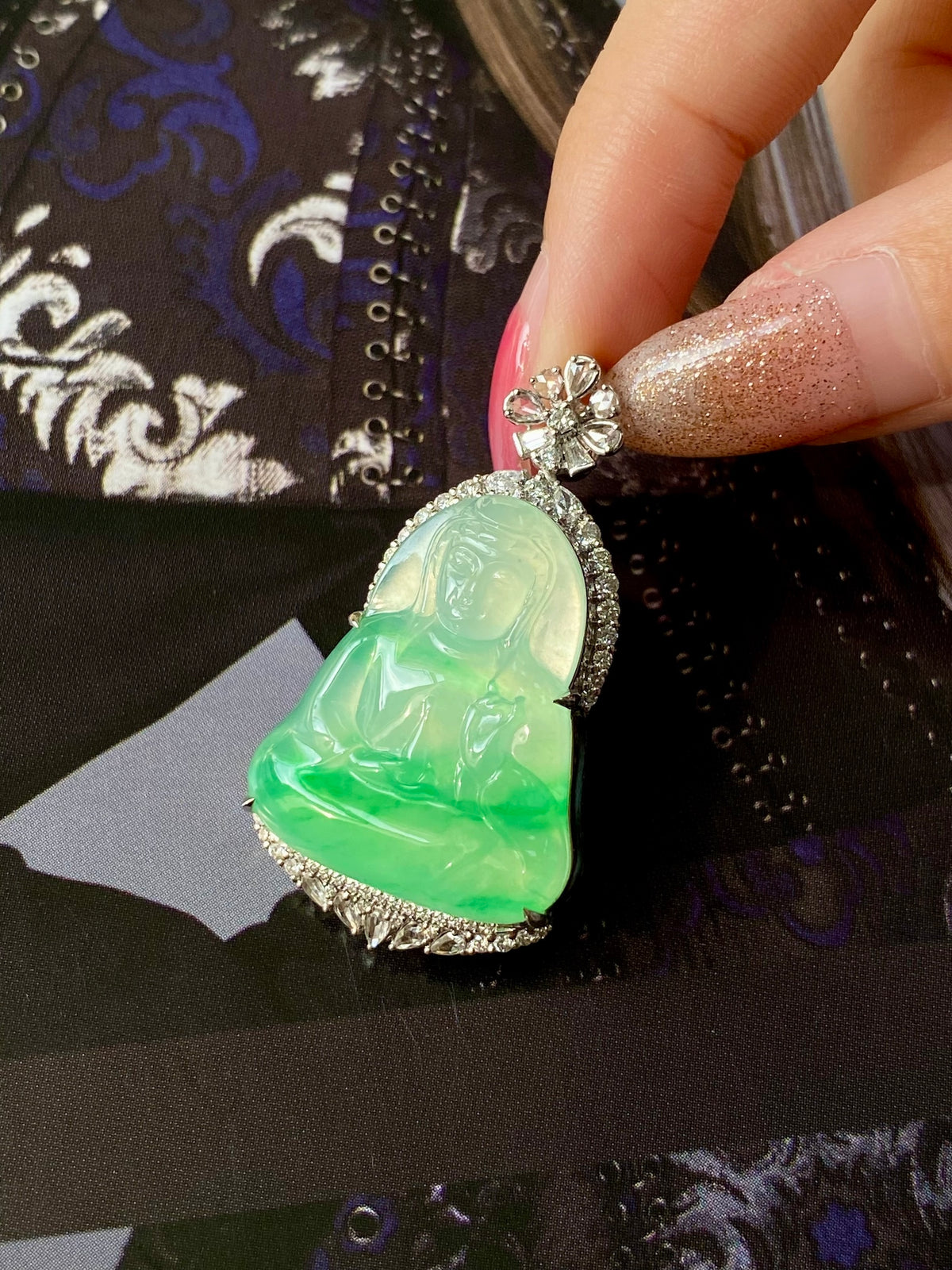 Apple green jade Guanyin heart pendant with silver prong edges and flower top