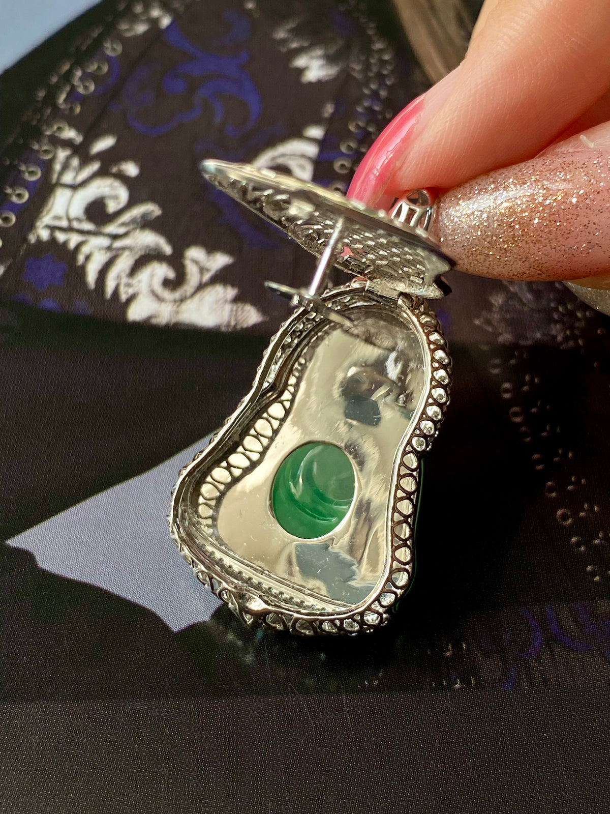 Green jade Guanyin heart pendant with silver filigree setting and round bail