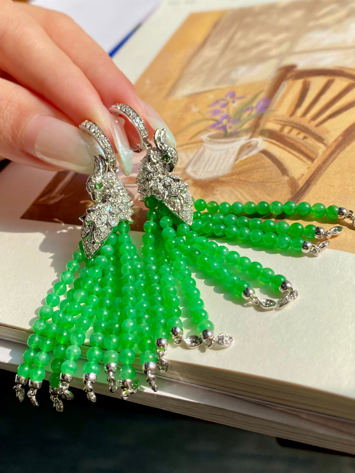 Peacock drop earrings featuring green bead strands and crystal-like silver details