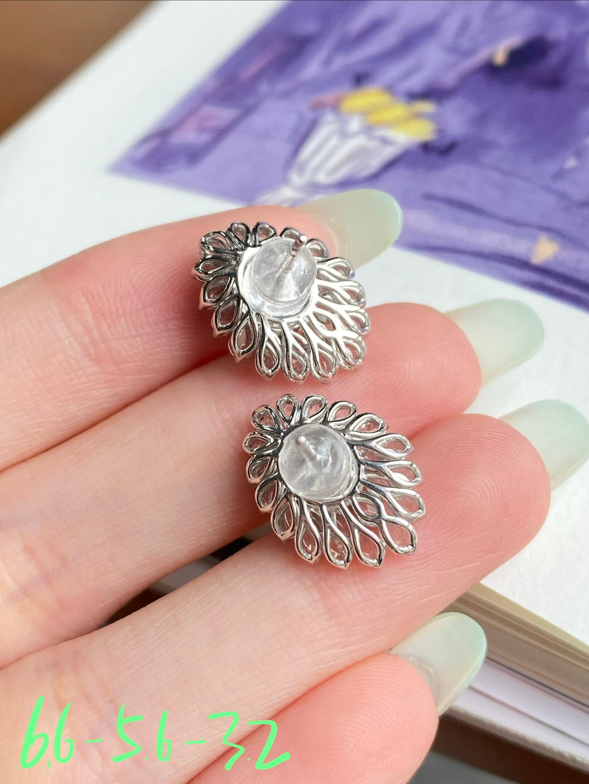 Silver-tone stud earrings with floral halo and clear cabochon stones