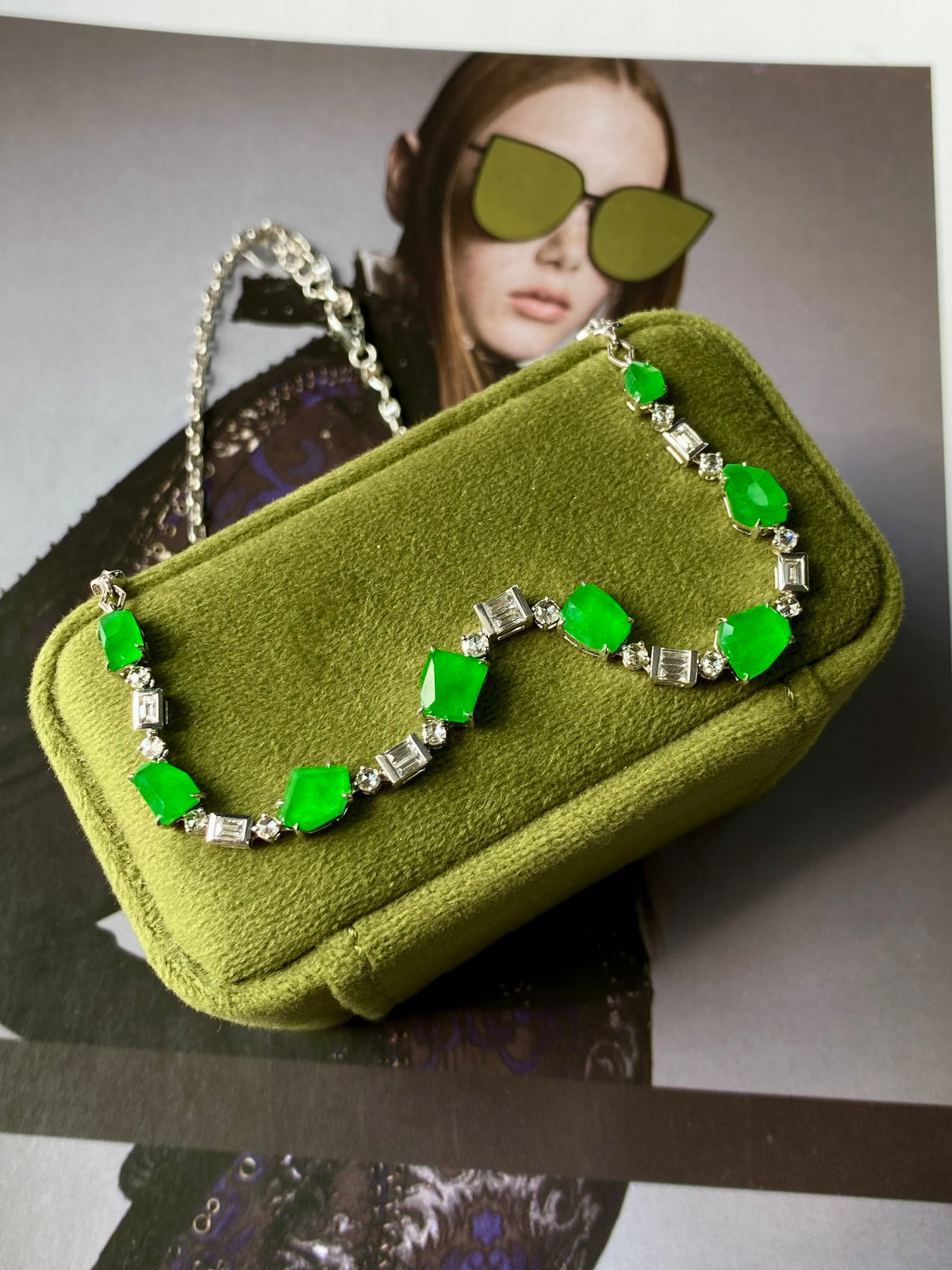 Green jadeite bead necklace with silver links and faceted green stones on pouch