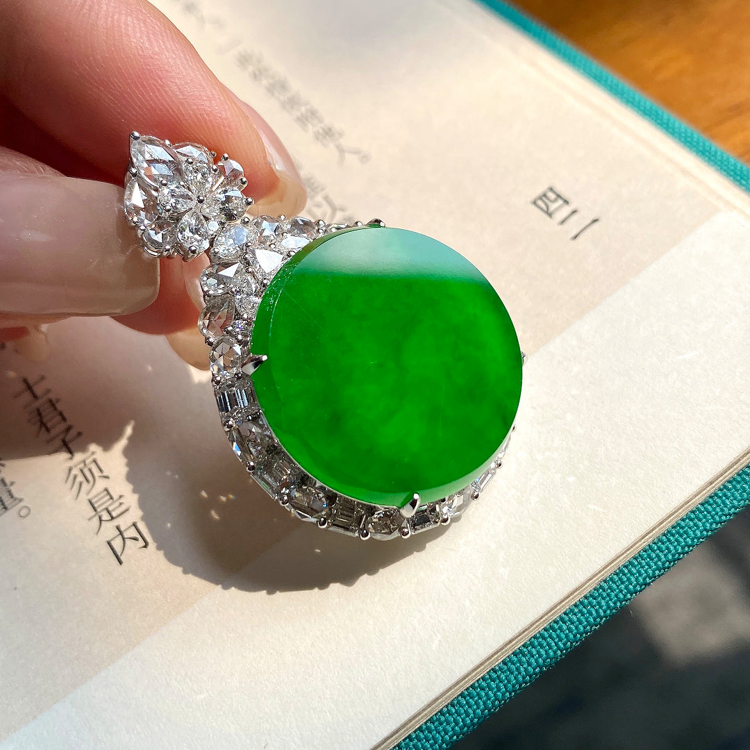 Green jadeite tablet pendant with round cabochon center and crystal-like border