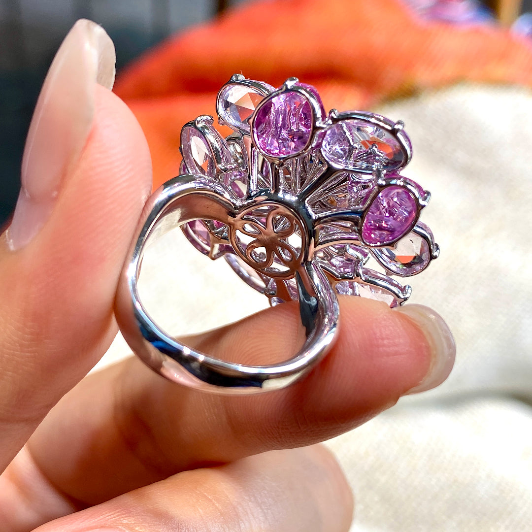 Floral gemstone ring in silver tone with oval opalescent center and purple side stones