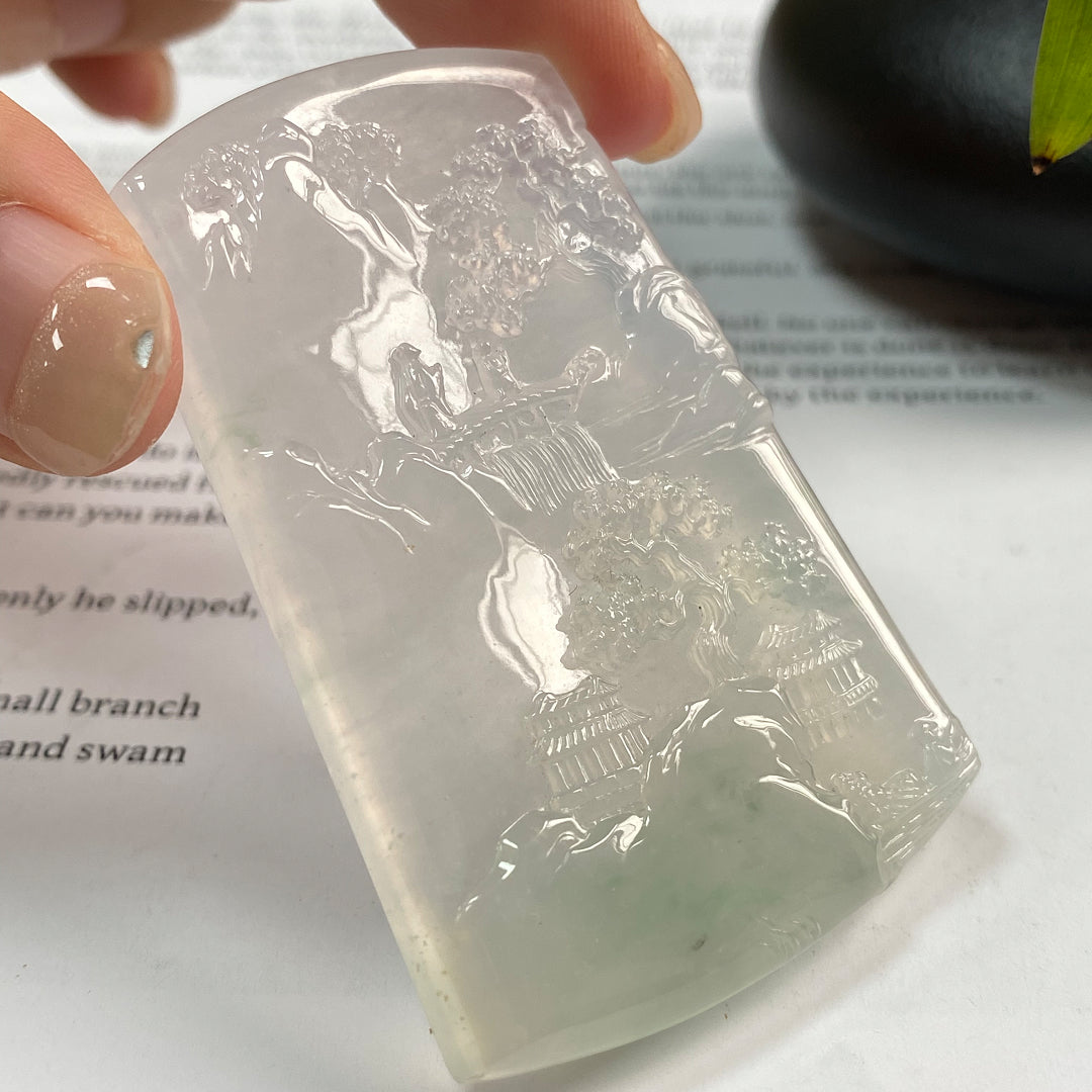Jadeite landscape pendant, angled view, translucent light stone with carved figures and houses