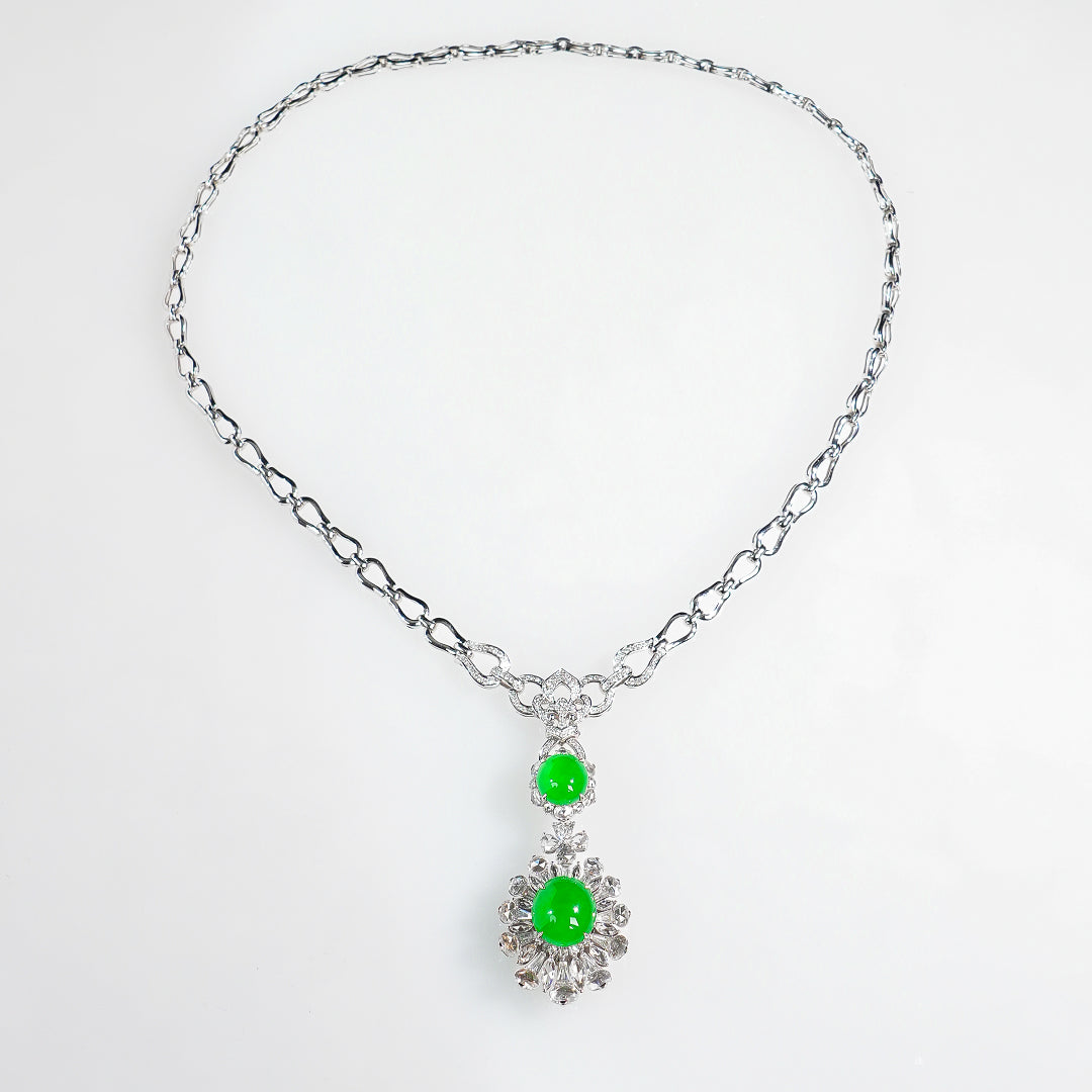 Silver-tone chain necklace with two green cabochon charms and crystal-like surrounds
