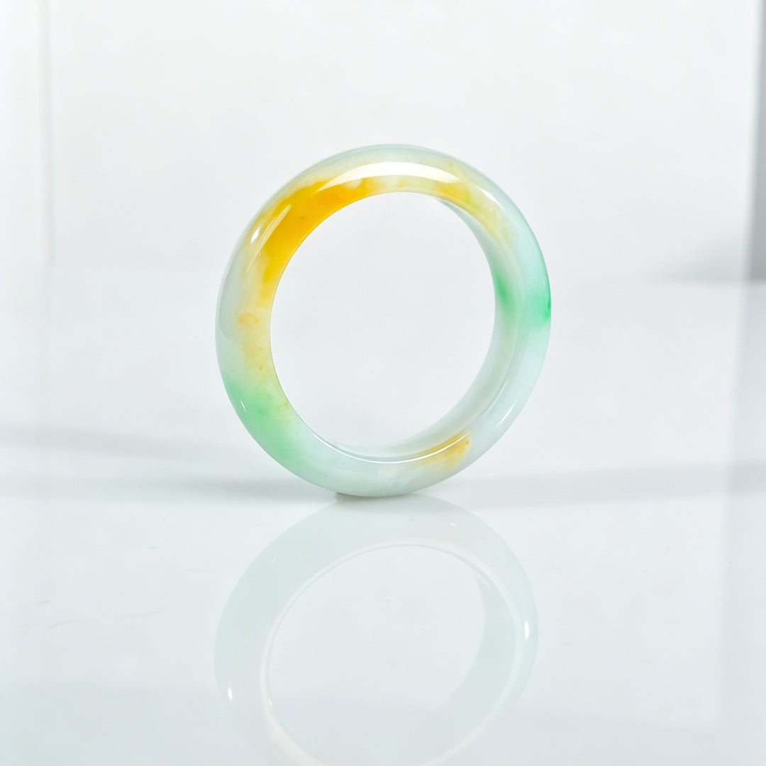 Three-color jadeite bangle with yellow band and green accents, glossy round bracelet