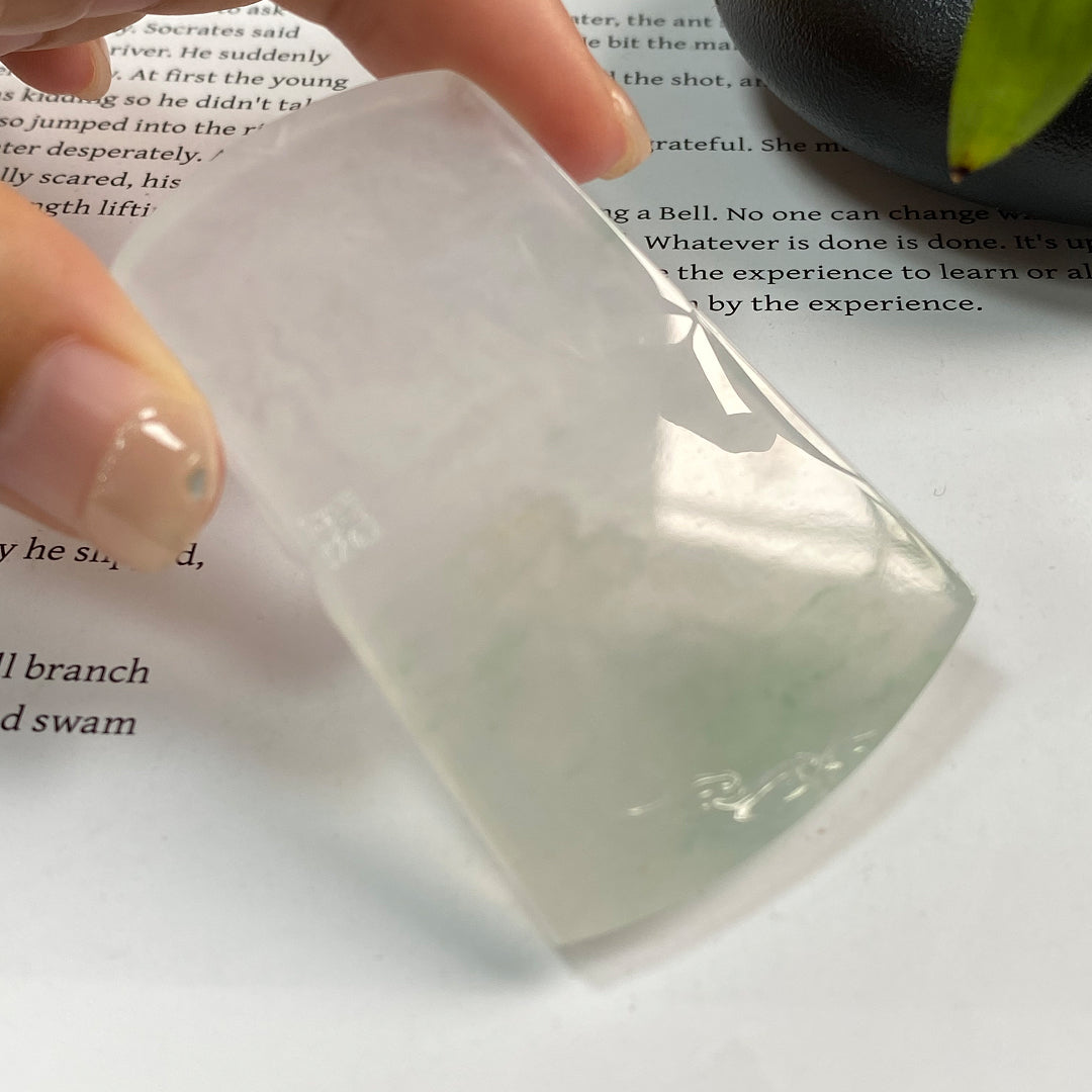 Jadeite landscape pendant, partial view, translucent light stone with raised scenery details