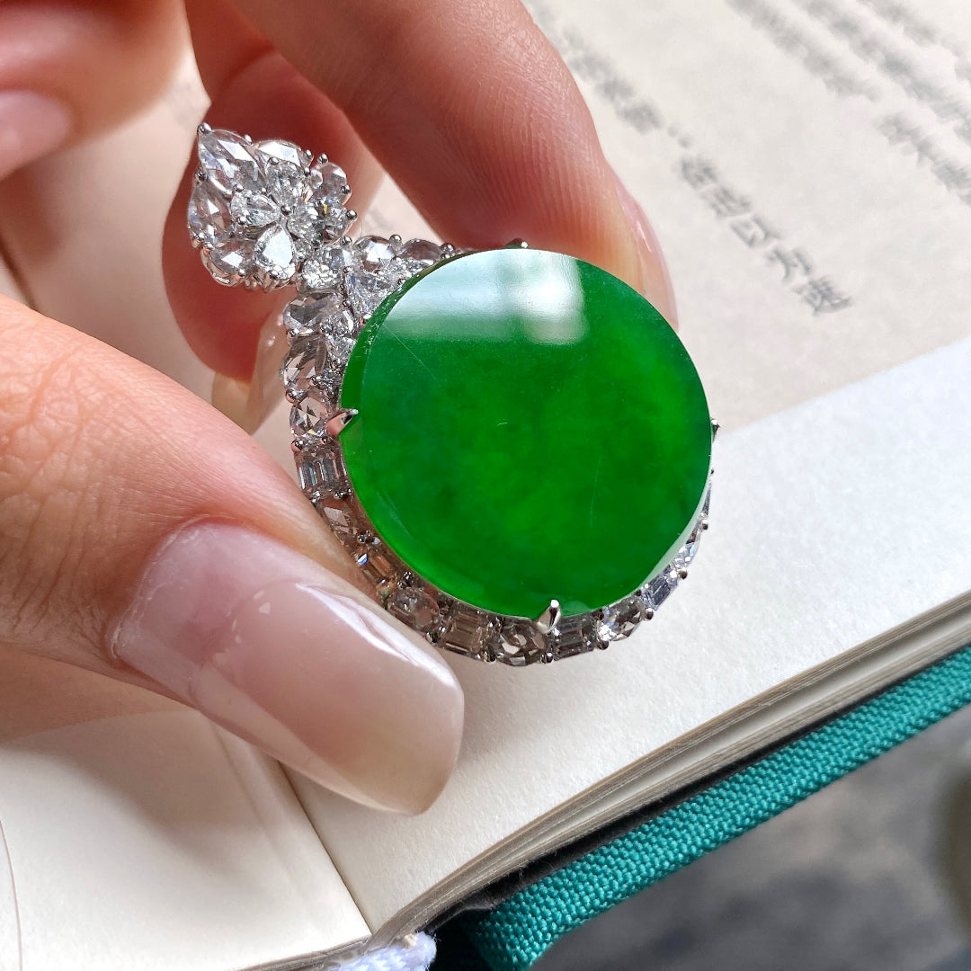 Green jadeite tablet pendant featuring a large cabochon center in diamond-like setting