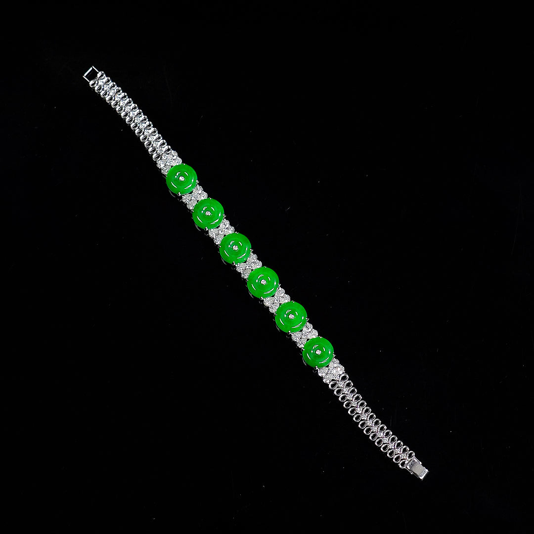 Green jadeite donut bead bracelet with silver chain and clear stone links, full length