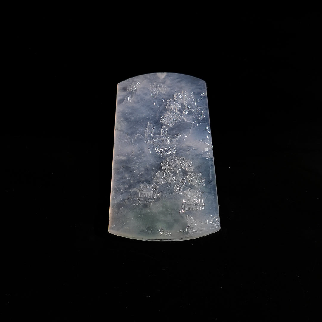 Rectangular jadeite landscape pendant, translucent bluish-gray with carved figures and scenery