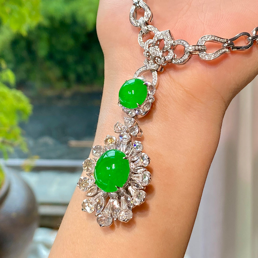 Silver-tone necklace with two green cabochon stones in diamond-like clusters