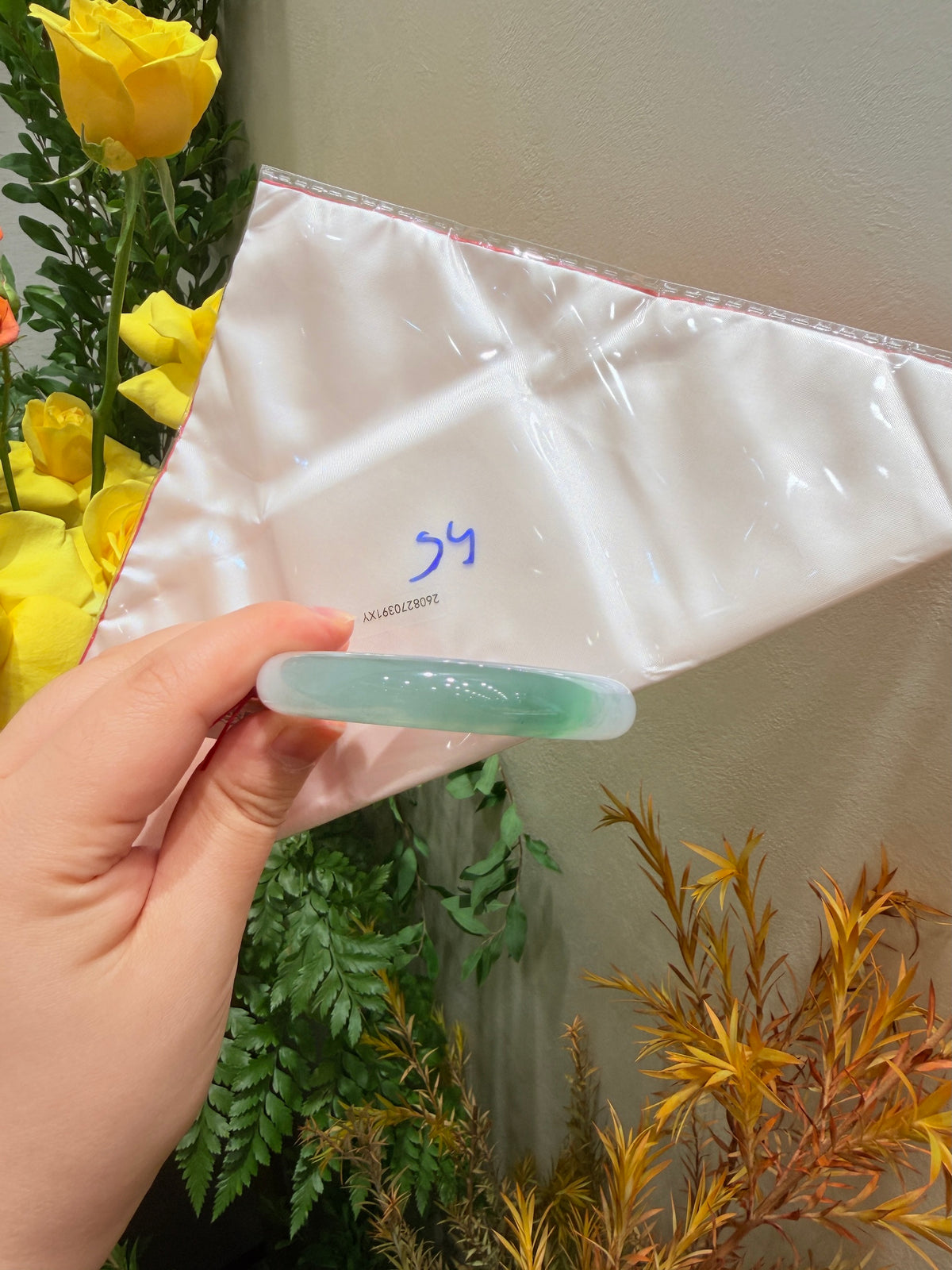 Light blue translucent bangle showing inner edge detail on white fabric wrap