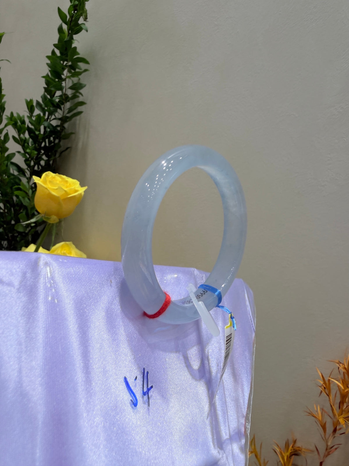 Light blue translucent bangle bracelet, standard width, glossy finish.